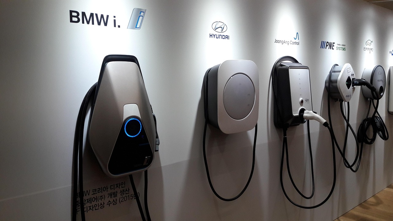 Row of wall-mounted EV chargers on a showroom wall