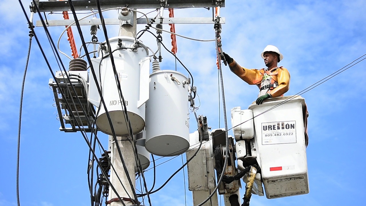 Electrical worker in a bucket truck working on overhead supply lines